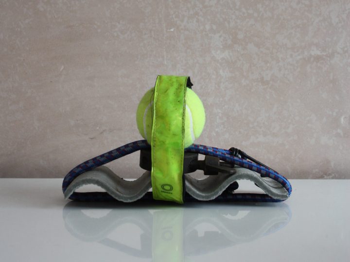 A small sculpture made using household objects including a fluorescent green tennis ball.